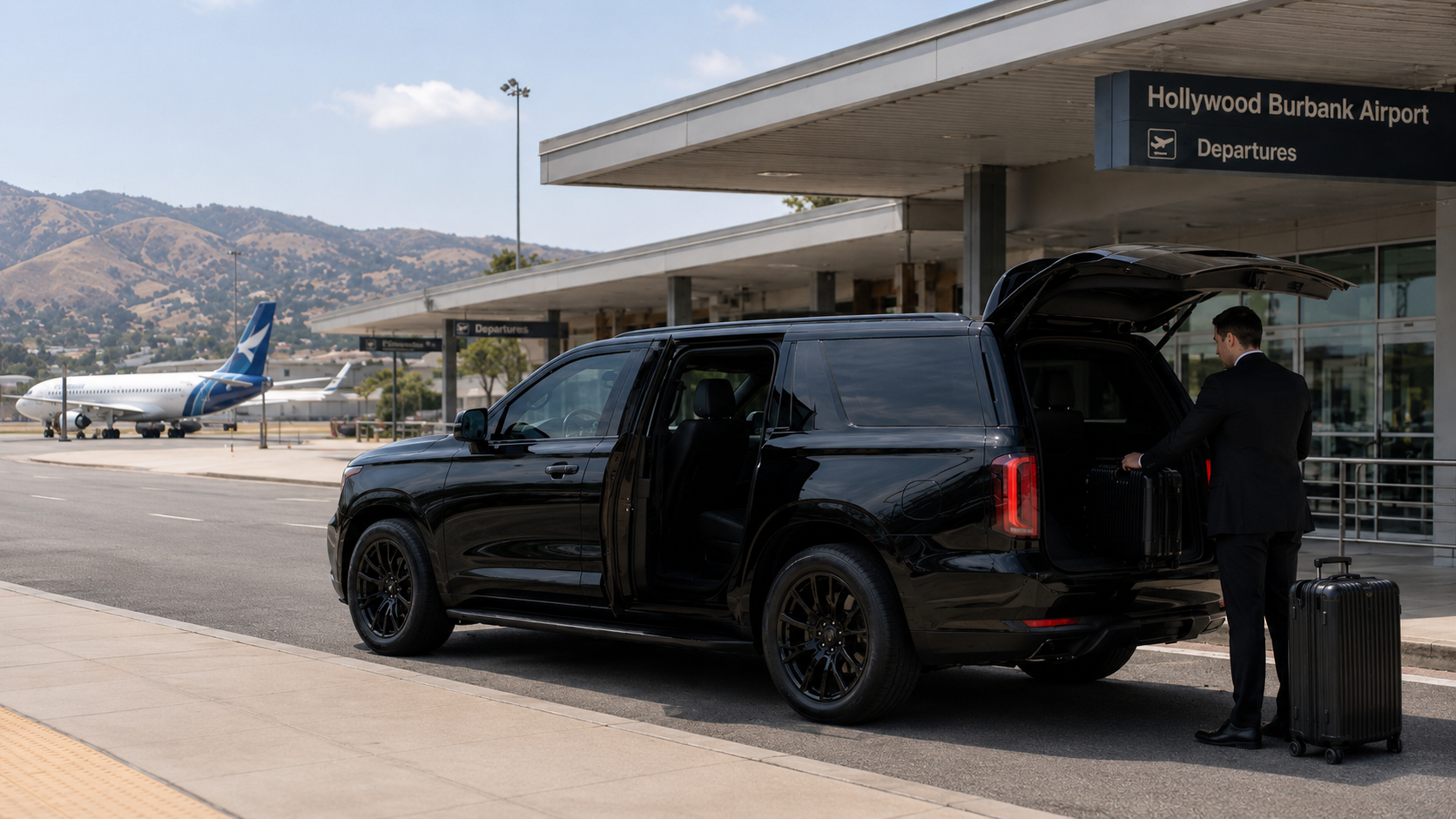 A C Ya Again Executive Transportation black luxury SUV with a professional driver outside Hollywood Burbank Airport (BUR).